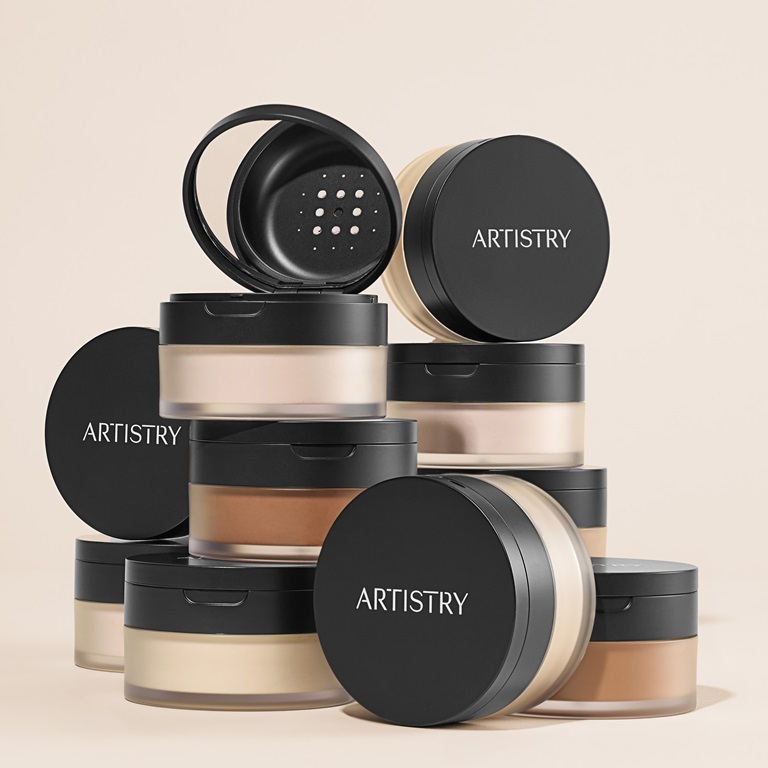 A stacked array of jars of Artistry Ever Perfect™ Loose Setting Powder in different shades.